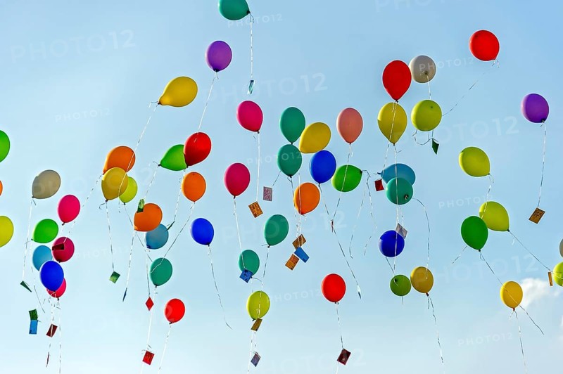 Colorful balloons rise to the sky