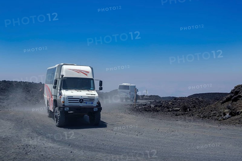 Four-wheel drive vehicles on gravel road to Etna volcano