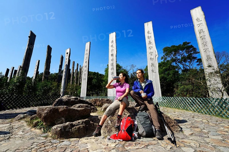 Hikers rest in front of wooden steles at Wisdom Path