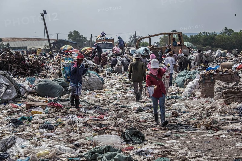 Garbage collectors on rubbish dump on the outskirts