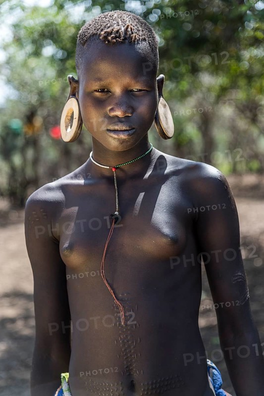 Young girl with ornamental scars on her body