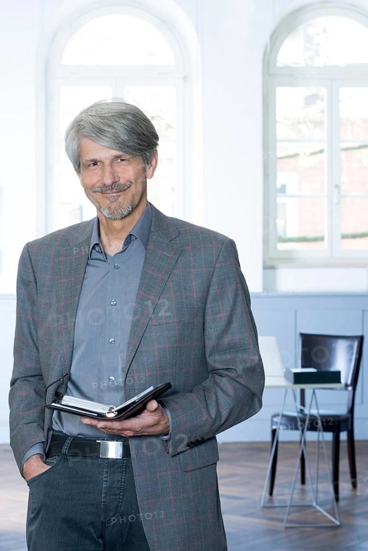 Man with calendar in front of his office window