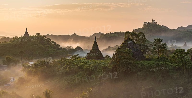 Mist over hills and stupas of Mrauk U at sunrise