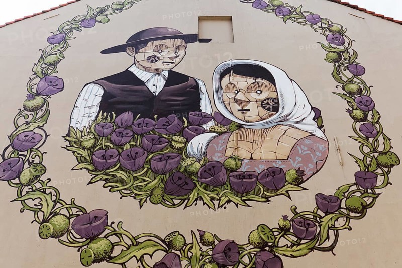 Medieval peasant couple in a wreath of flowers
