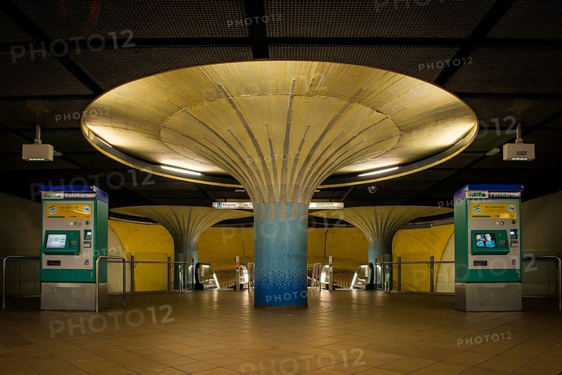 Illuminated column in entrance hall with ticket machine