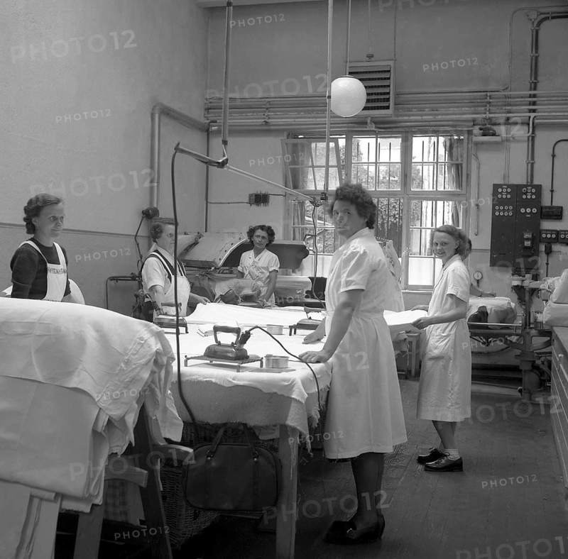 Women folding and ironing textiles