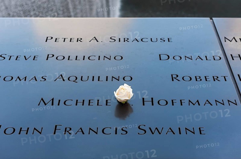 Names of 9/11 victims on pool parapet with white rose