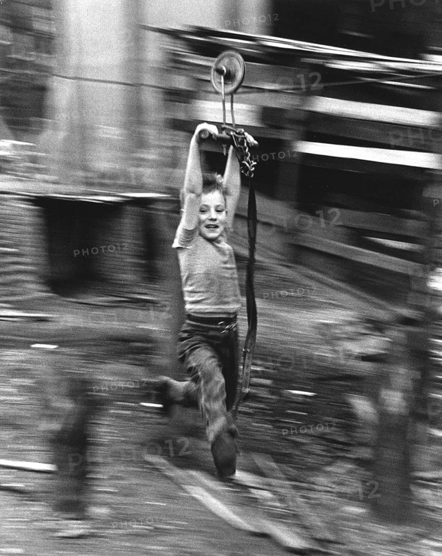 Boy hangs on wire rope