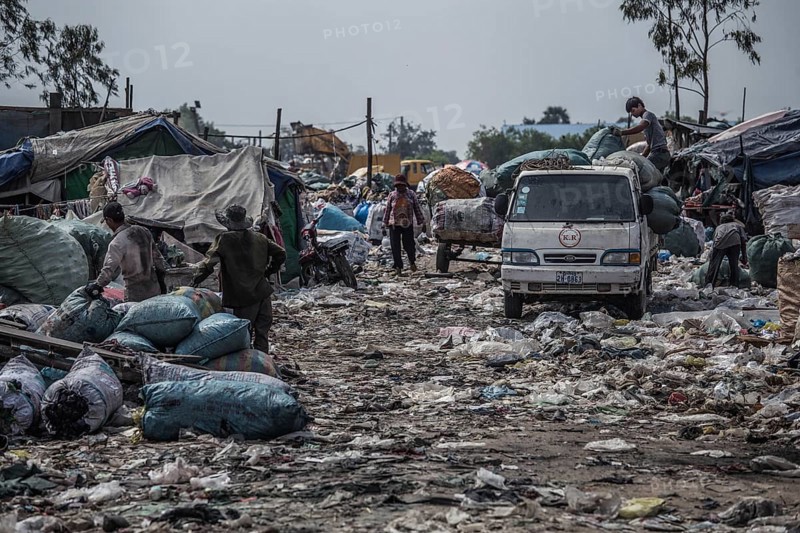Garbage collectors on rubbish dump on the outskirts