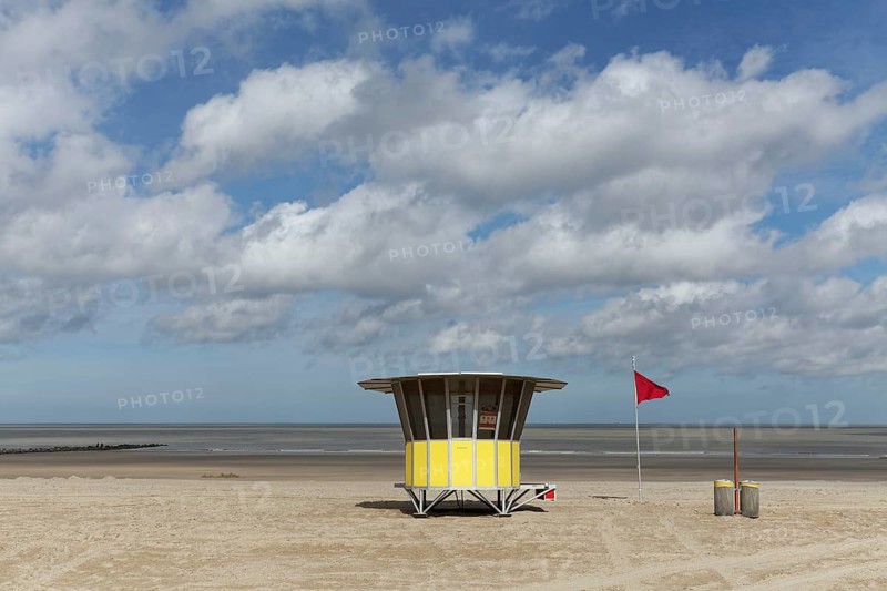 Sandy beach with modern beach guard hut