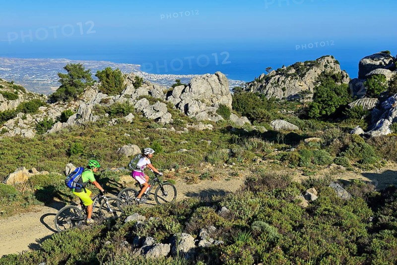 Two mountain bikers ride through Macchia