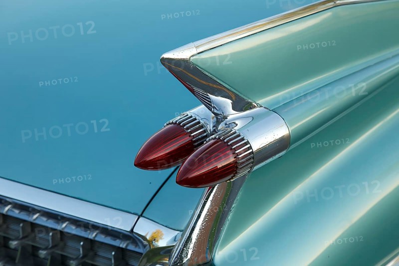 Tail fins with red tail lights of an american vintage car