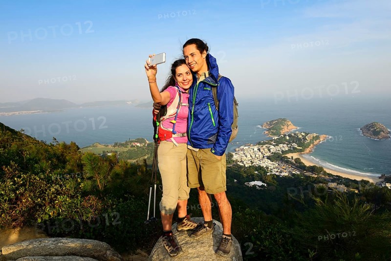Hikers taking a selfie on a rock