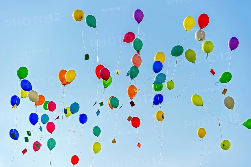 Colorful balloons rise to the sky