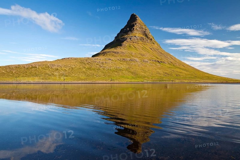 Mount Kirkjufell with water reflection in the fjord Grundarfjordur