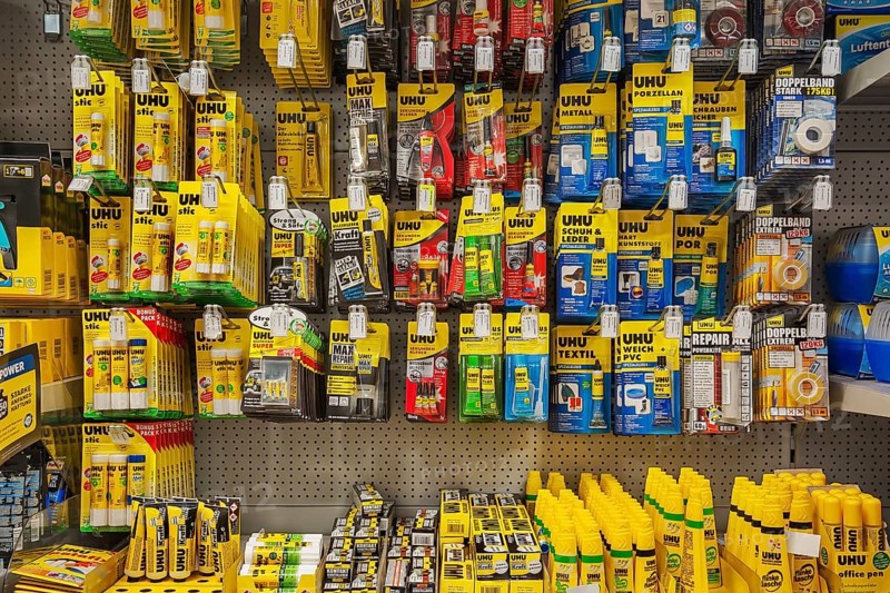 Various adhesives on shelves