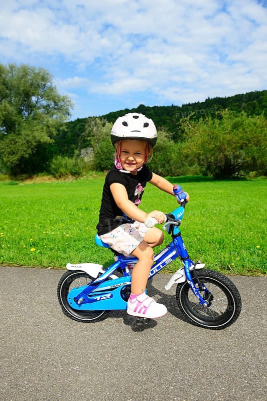 Girl rides on children's bike