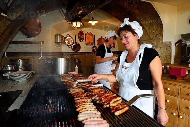 Sausages sizzle on the grill
