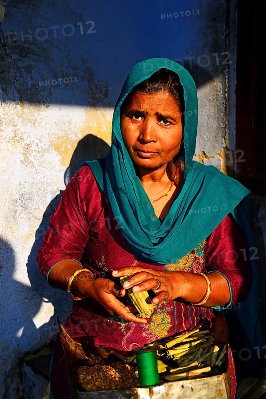 Woman wraps cigarettes into a bundle