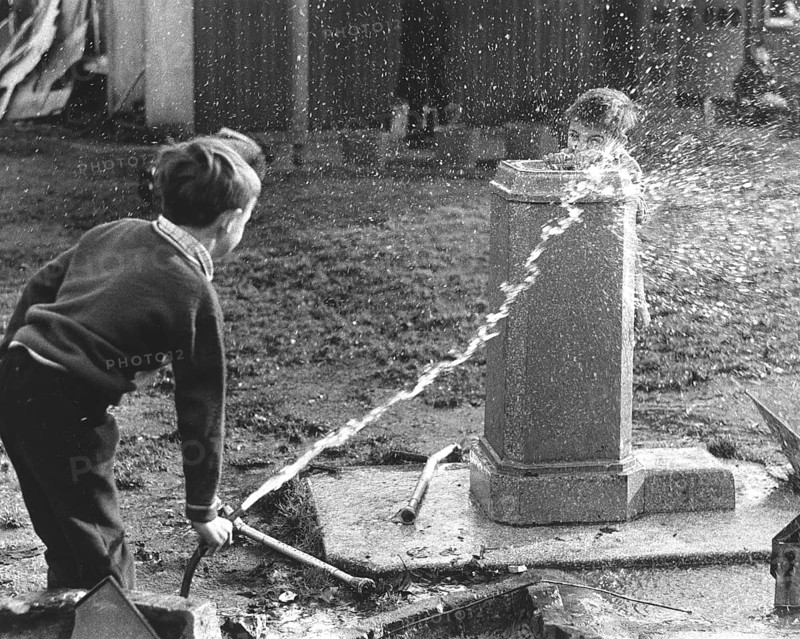 Children squirt with hose