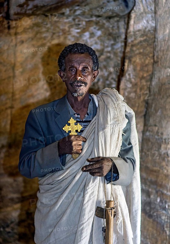 Orthodox priest inside the rock church Medhane Alem