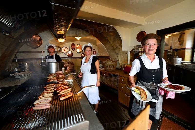 Sausages sizzle on the grill