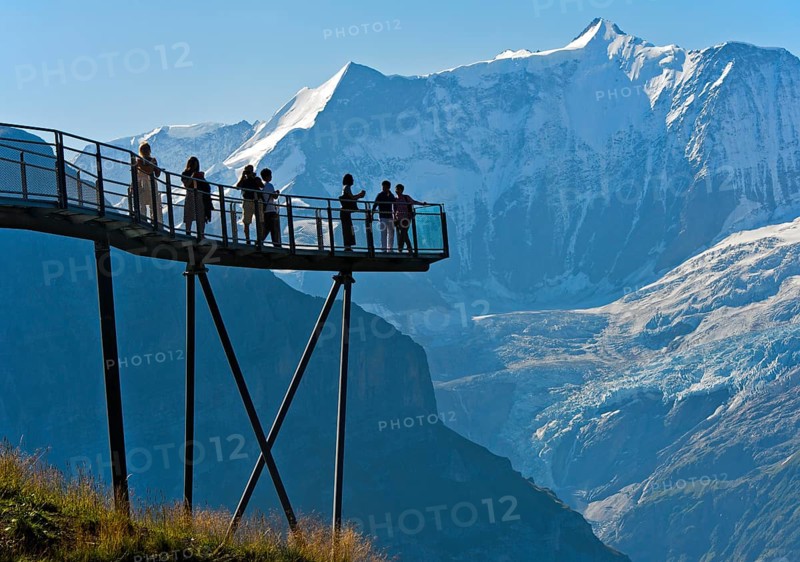 Tourists on the observation deck of the First Cliff Walk by Tissot in front of the Fiescherhorn north face and the Grindelwald glacier