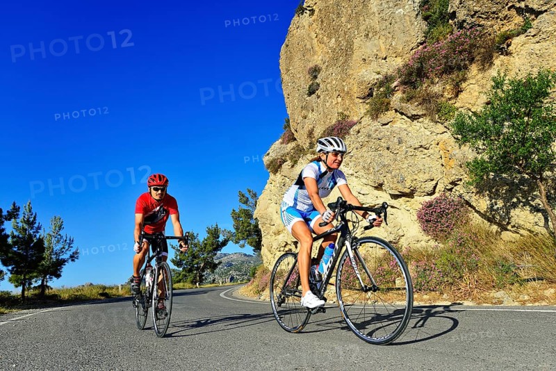 Two racing cyclists on a winding road