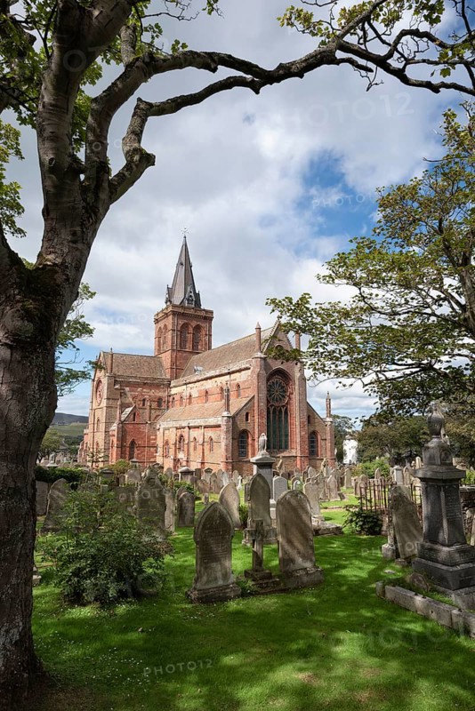 Old gravestones on cemetery and Romanesque-Norman cathedral St. Magnus