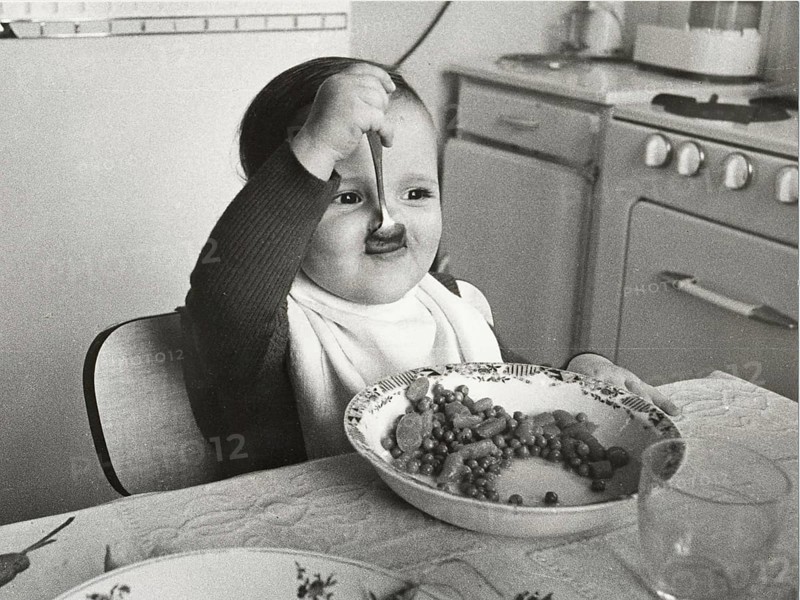 Toddler eats with spoon