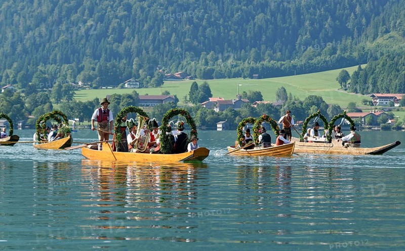 Men wearing traditional costumes in festively decorated squares