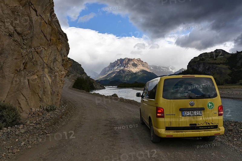Yellow travel minibus on road to Lago del Desierto at Rio de las Vueltas