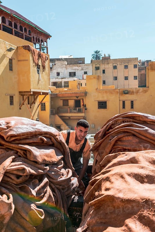 Worker dyeing leather