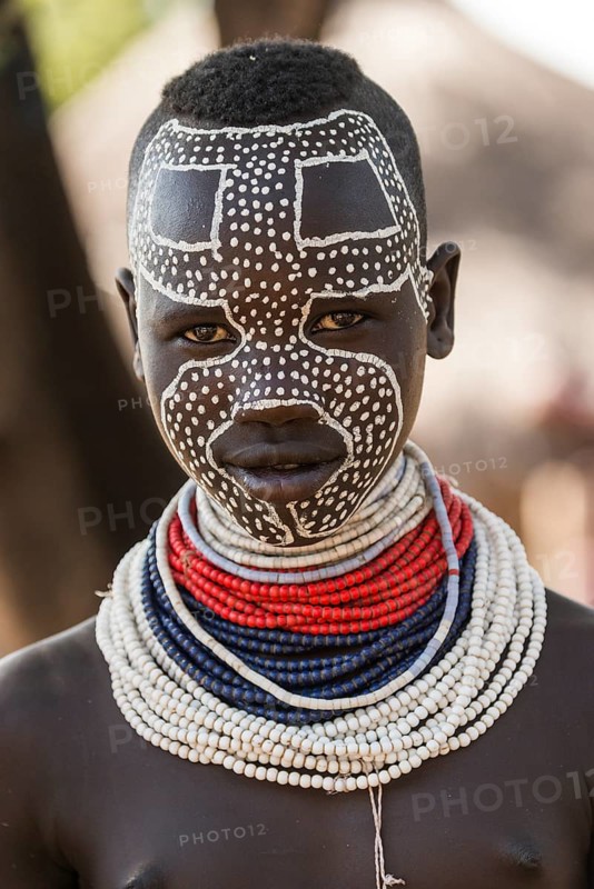 Young woman with traditionally painted face