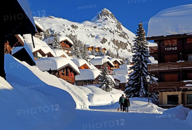 Village road with snow-covered chalets