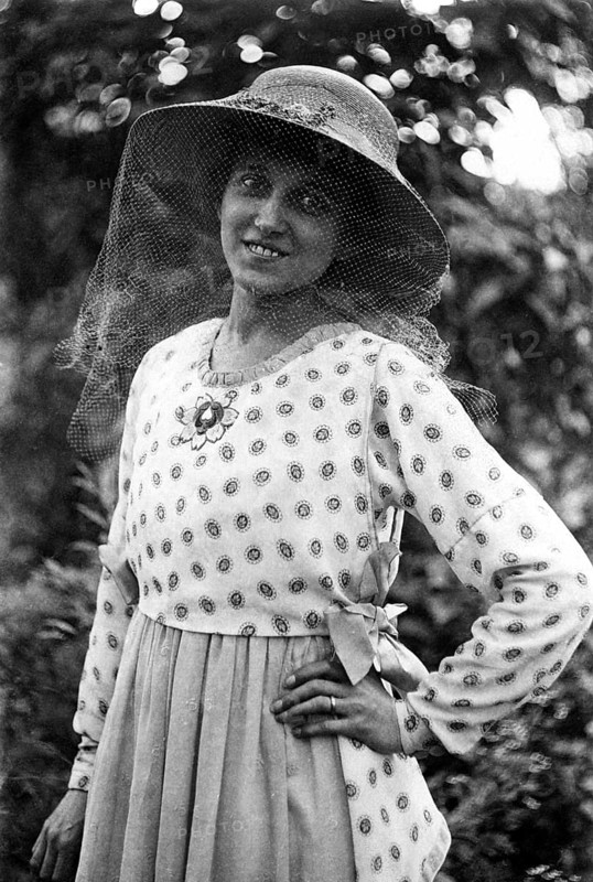 Woman with hat and mosquito net on her face