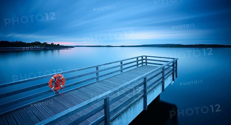 Pier in the harbour with life belt