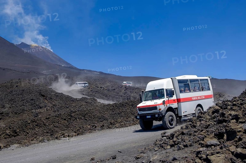 Four-wheel drive vehicles on gravel road to Etna volcano