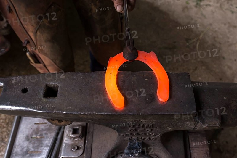 Glowing horseshoe on an anvil