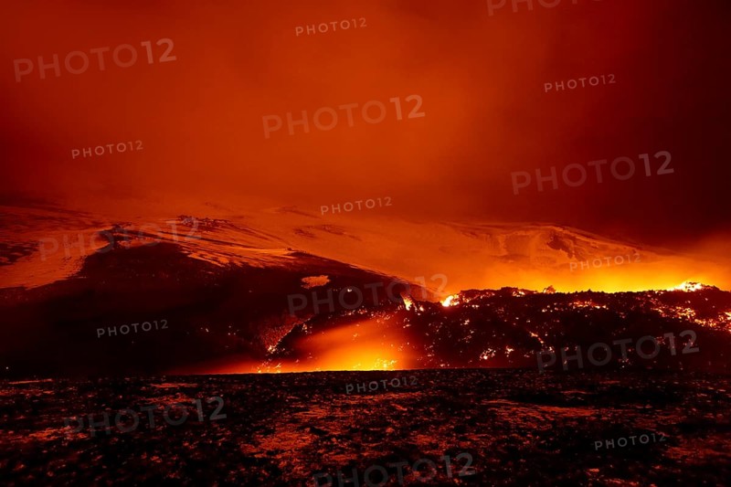 Glowing lava and lava flow at night on Fimmvorouhals volcano