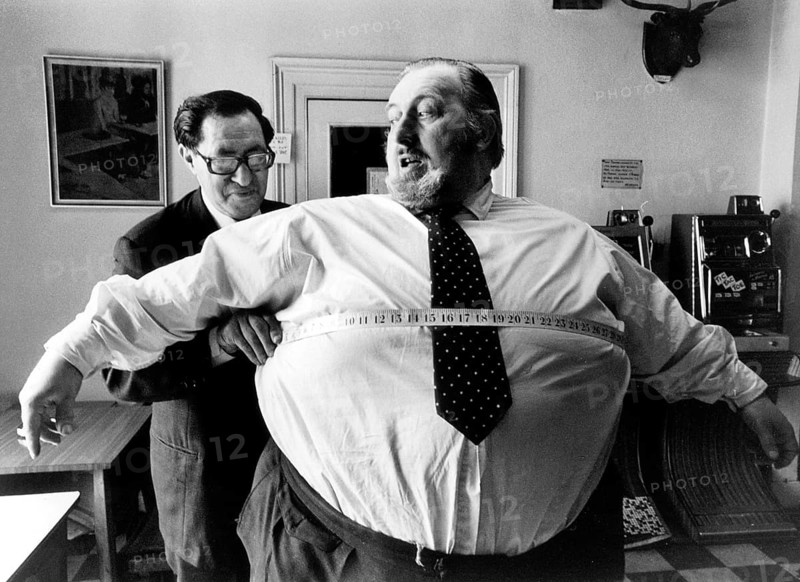Thick man is measured by the tailor