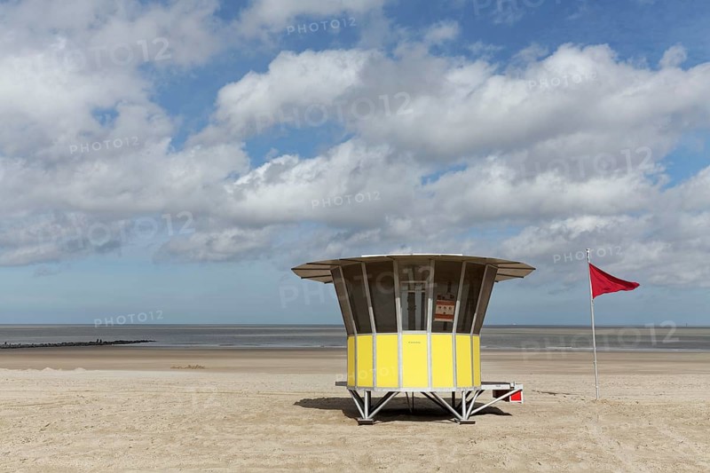 Sandy beach with modern beach guard hut