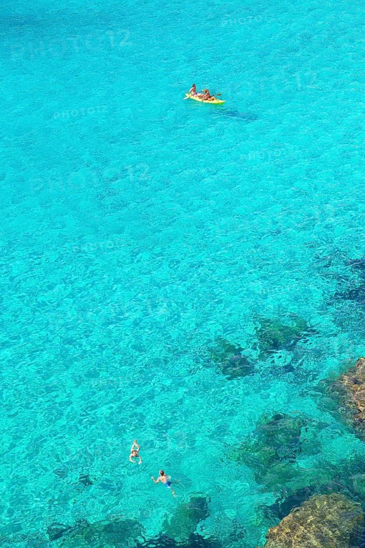 People canoeing and swimming at Cala Mitjana