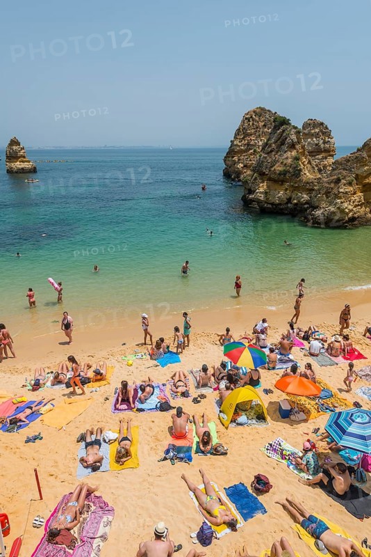 Tourists and bathers at the sandy beach