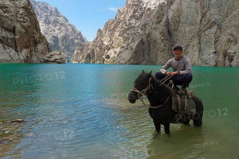 Kyrgyz showing his agility on his horse in Kol-Suu lake