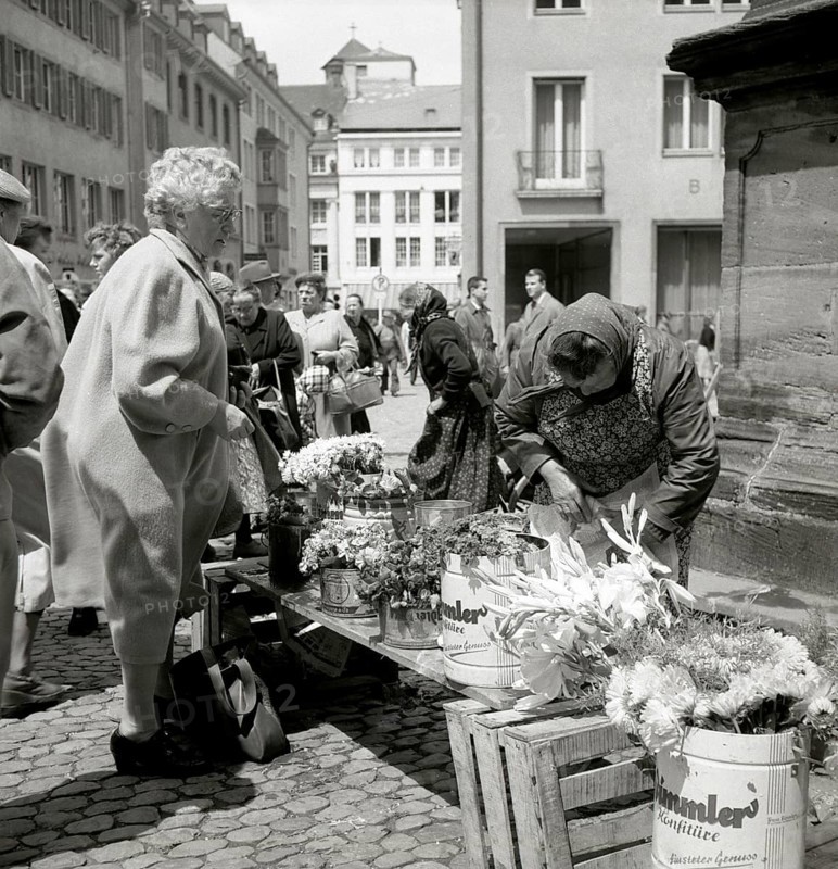 Elderly lady buys a bouquet of flowers