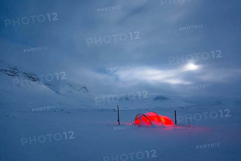 Tent by full moon in the snow