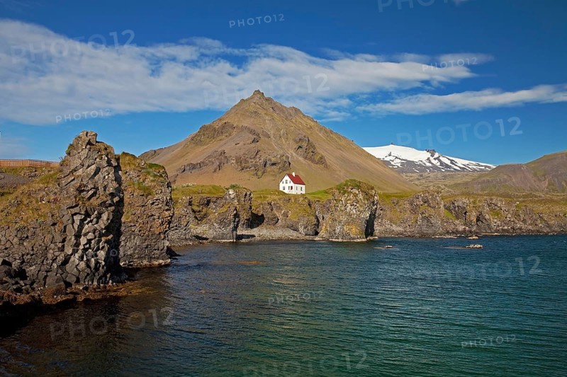 House on the basalt coast off Stapafell mountain and Snaefellsjoekull glacier