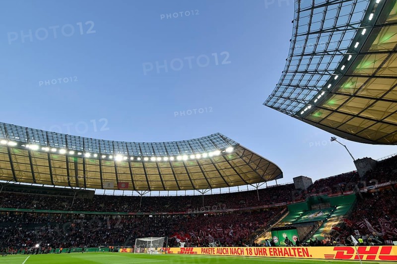 Football stadium illuminated with perimeter advertising