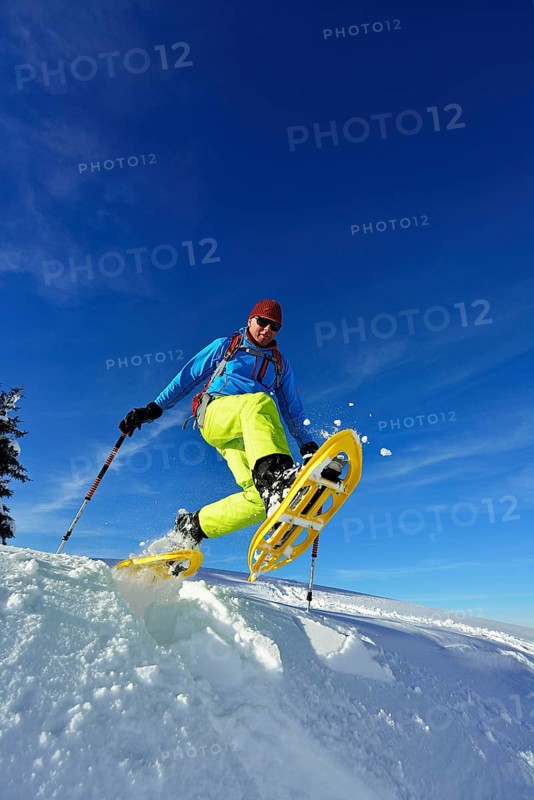 Snowshoe walker with big steps in the snow